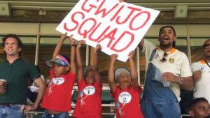 gwijo squad sign children holding it at cricket